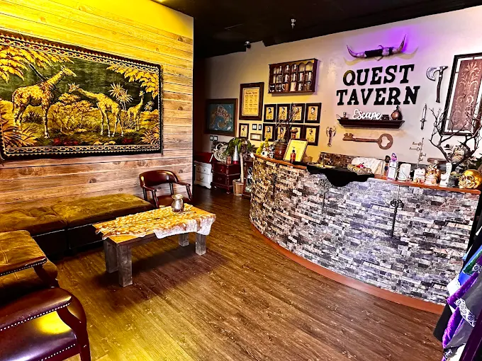 Quest Tavern Escape Room lobby in Pomona, CA with rustic tavern bar, seating area, and fantasy wall decor.